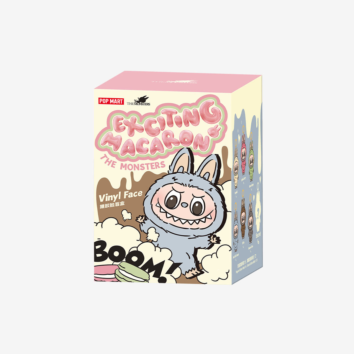 Packaging box of Pop Mart Labubu “Exciting Macaron” series featuring a grey fuzzy Labubu character with bunny ears on the front and a lineup of collectible designs illustrated on the side.