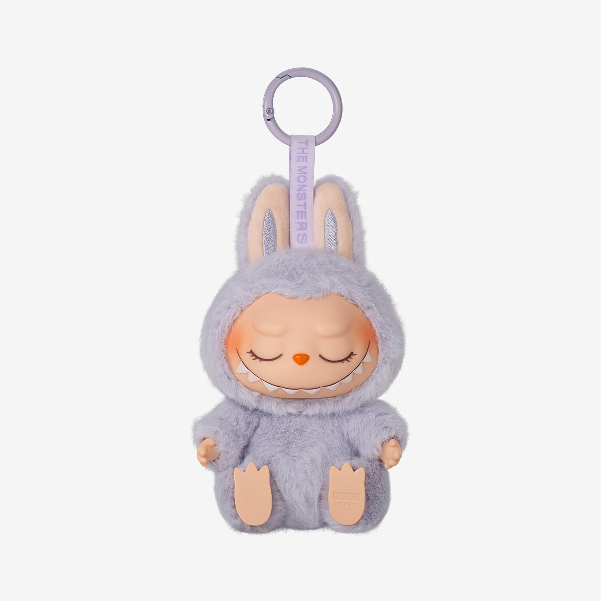 Labubu Zizi keychain plush from the "Have a Seat" series, featuring a soft peach furry costume with bunny ears and wide-eyed smile, sitting with legs stretched forward.