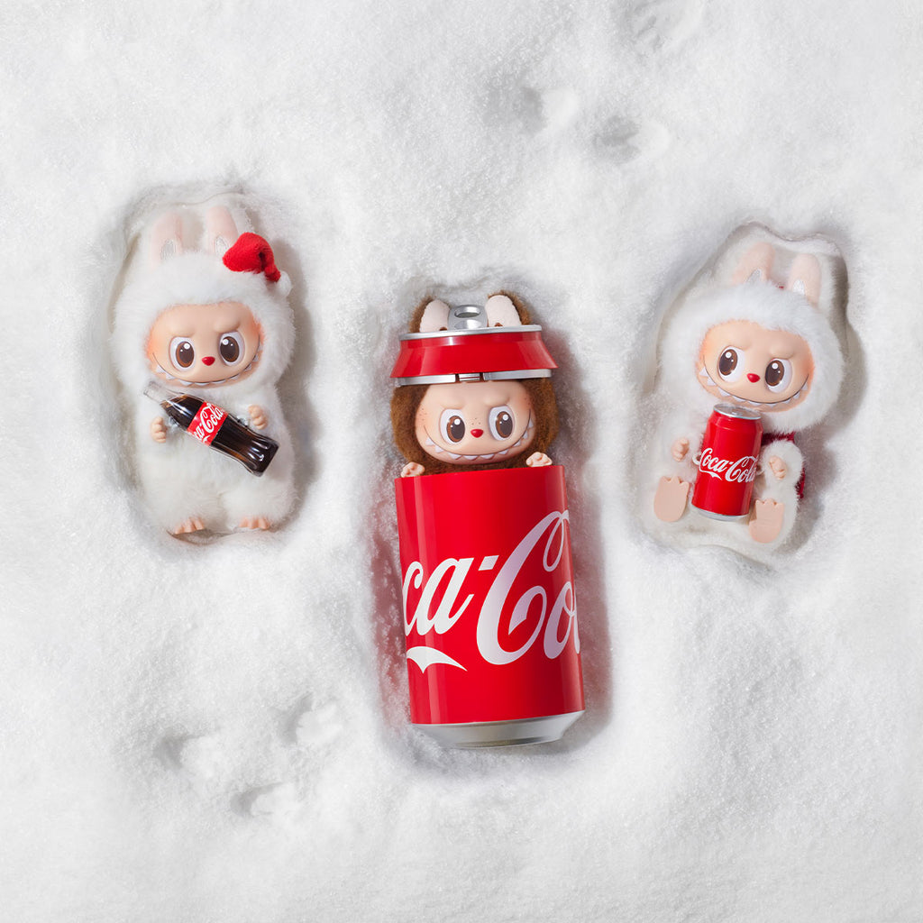 Coca cola edition labubu dolls on snow flat lay 