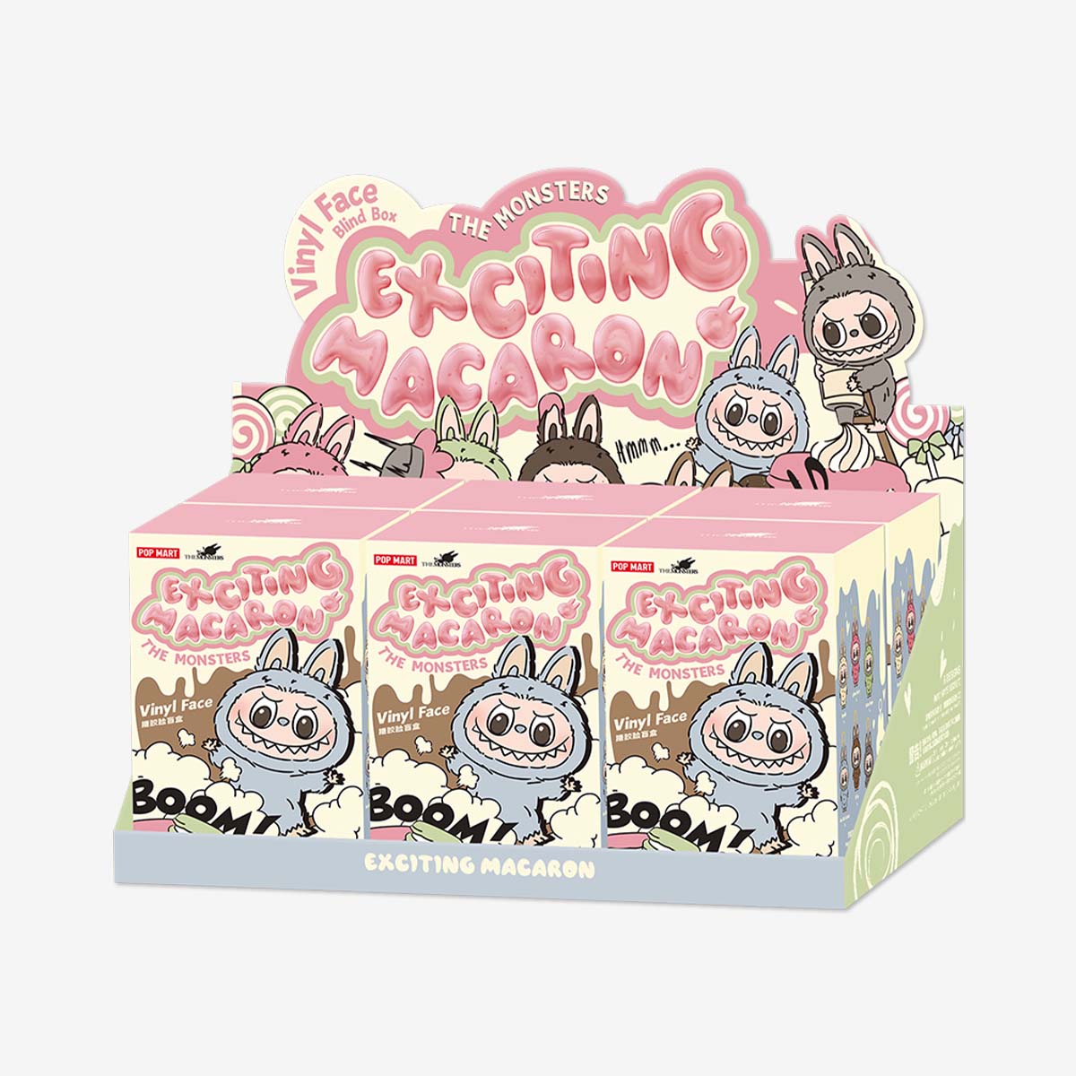 Display box of Pop Mart Labubu "Exciting Macaron" vinyl face blind box series, featuring colorful pastel packaging with cartoon illustrations of Labubu characters in bunny suits and playful macaron-inspired designs.